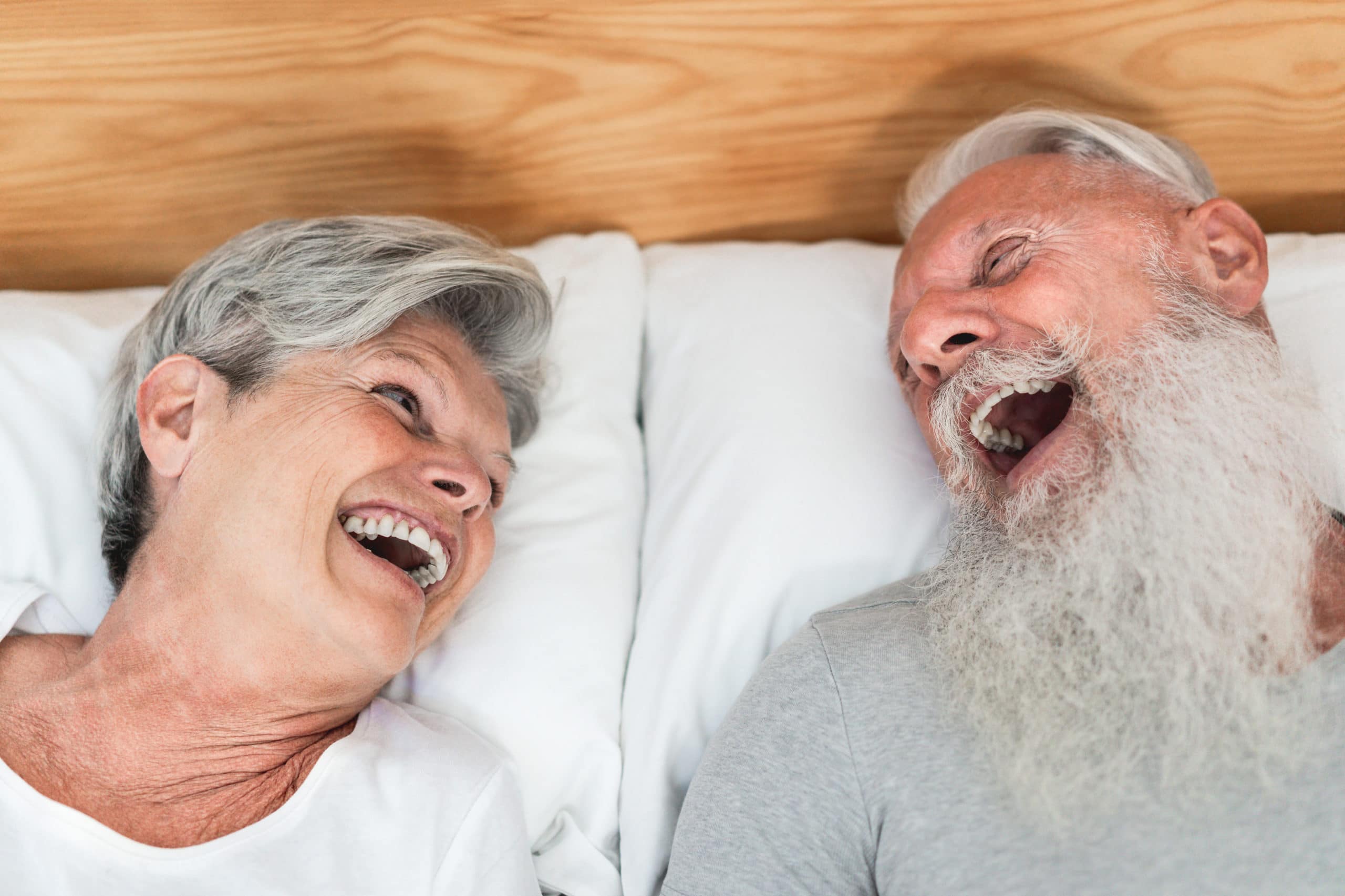 Glückliches verheiratetes Seniorenpaar, das Spaß im Bett hat